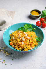 Yellow Turmeric Rice with Vegetables on Bright Background