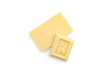 Pieces of a white chocolate bar on a white background. Top view.