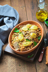 Rice with Meat Fillet and Bananas on Wooden Background