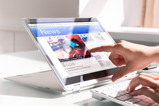 Watching News On Screen. Reading Newspaper Website