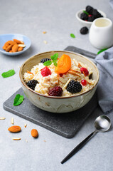 Spelt Porridge with Fruits, Berries, and Nut Topping, Healthy Breakfast or Snack