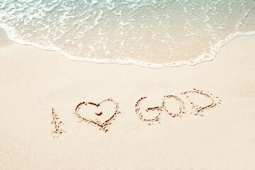 beautiful drawings inscription on the sand of the sea in the summer on the nature