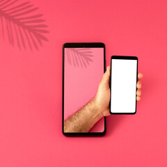 A black mobile phone with a hand coming out of it with a mobile phone in it, on a pink background,...
