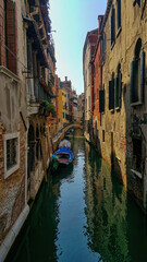 Colorful buildings over the canal in Venice in the late afternoon sun. 