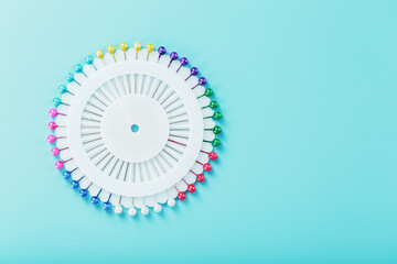 Sewing mother-of-pearl pins in a round white package