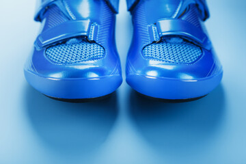 Blue highway cycling shoes on a blue background