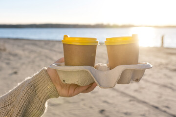 coffee in a stand in craft cups on the river or sea shore