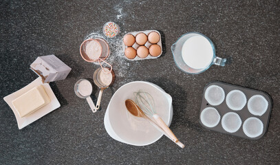 Top view, baking product and kitchen counter with eggs, flour and butter utensils on table. Food and cooking ingredients on a table to bake meal or dessert with protein and nutrients from above