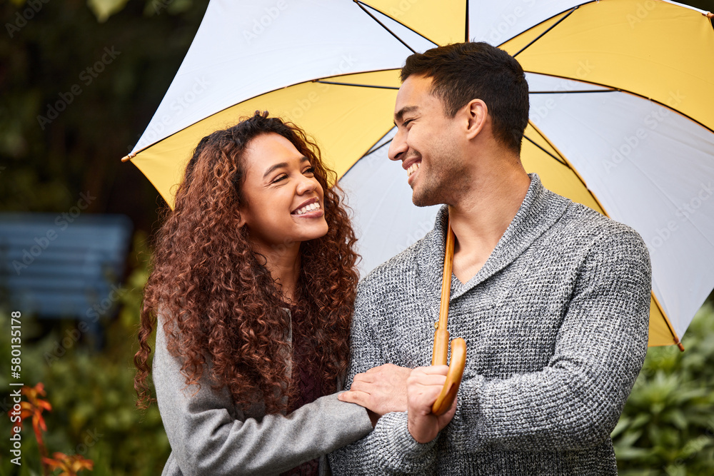 Canvas Prints We can get through the storm together. Shot of a young couple standing in the rain with an umbrella.