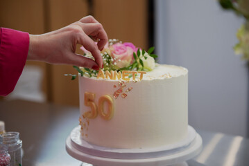Confectioner decorates a birthday cake