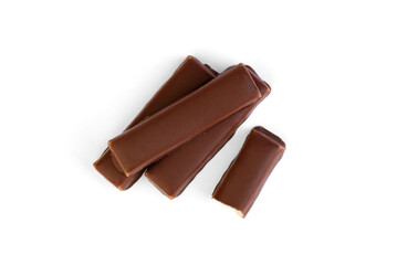 Pile of chocolate candy with milk praline filling on a white background.