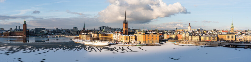 Panoramic view of Stockholm's most notable landmarks: old town, city hall and cathedral spires, sunny winter day