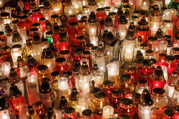 Decorative votive candles during All Hallows' Day at the cemetery.