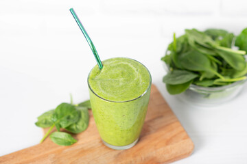 Healthy green smoothie and ingredients on white - spinach, apple and kiwi. detox and healthy food.