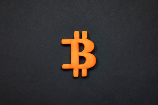 Symbol of bitcoin crypto currency. 3d Golden bitcoin sign on black background concept.   Financial market and investment.