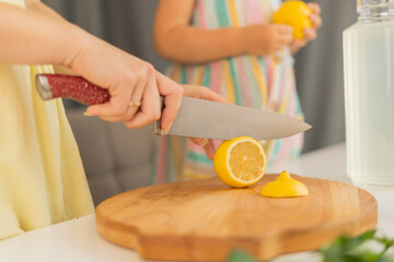 Hands of woman cutting lemons