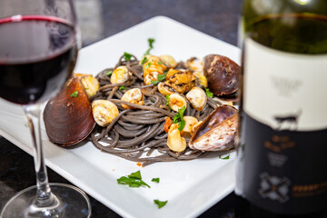 Black spaghetti with sepia squid ink with seafood, clams and shells
