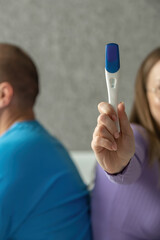 Negative pregnancy test in the hands of a young woman. Conscious denial of pregnancy, childfree....