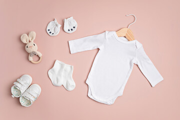 Mockup of white infant bodysuit made of organic cotton with eco friendly baby accessories. Onesie...