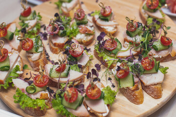 Office party catering, table with variety of different food snacks on a workplace, sandwiches, croissants and appetizers on a party event or celebration, coffee break for colleagues and employees