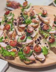 Office party catering, table with variety of different food snacks on a workplace, sandwiches, croissants and appetizers on a party event or celebration, coffee break for colleagues and employees
