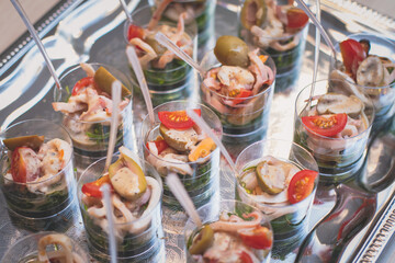 Fototapeta na wymiar Office party catering, table with variety of different food snacks on a workplace, sandwiches, croissants and appetizers on a party event or celebration, coffee break for colleagues and employees