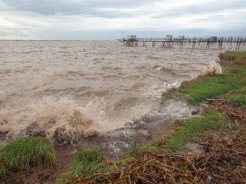 Weather storm on intertidal estuary and coastal erosion with waves on Atlantic coast, France