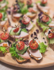 Office party catering, table with variety of different food snacks on a workplace, sandwiches, croissants and appetizers on a party event or celebration, coffee break for colleagues and employees