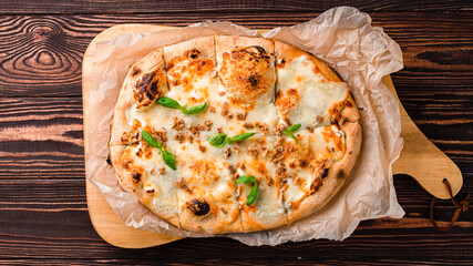 Italian cheese pizza with basil and spices on a thick dough.