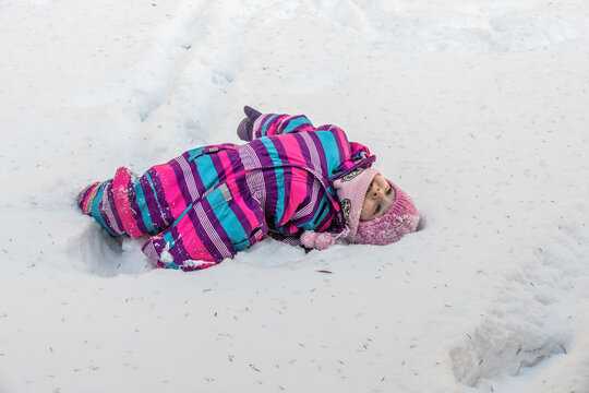 A little girl enjoys the sunny and cold winter wonderland of the north.