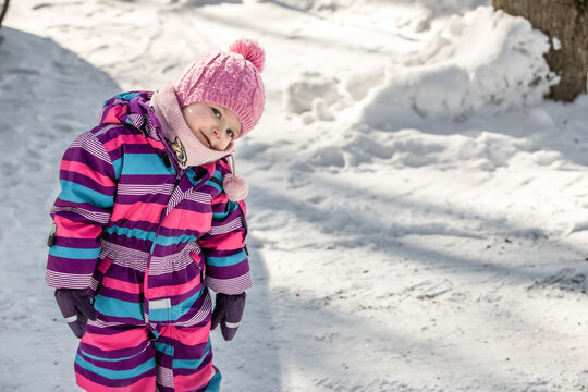 A little girl enjoys the sunny and cold winter wonderland of the north.