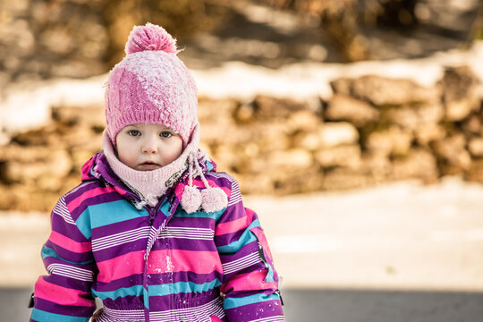 A little girl enjoys the sunny and cold winter wonderland of the north.