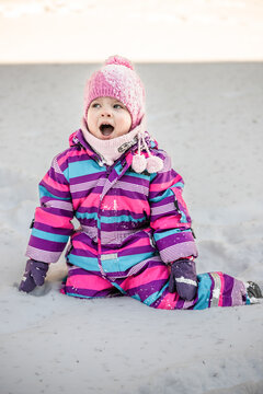 A little girl enjoys the sunny and cold winter wonderland of the north.