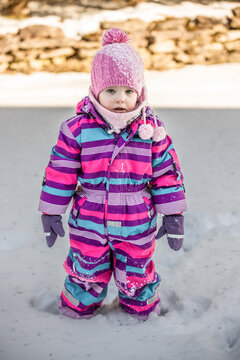 A little girl enjoys the sunny and cold winter wonderland of the north.
