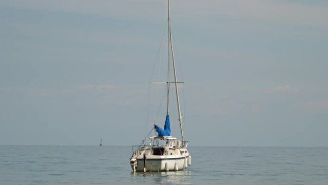 Sailing ship yacht with sails at opened waters. Sailboat at summer. Boat or yacht in calm water. Scarborough Bluffs.