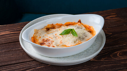 Italian lasagna with bechamel sauce, bolognese and basil.