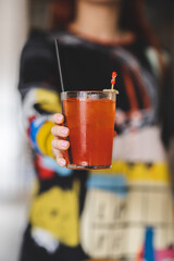 Cocktail party. Women hands with colorful drinks on bokeh background. alcohol party