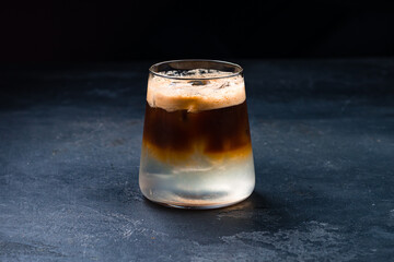 Coffee alcoholic drink with ice in a glass.