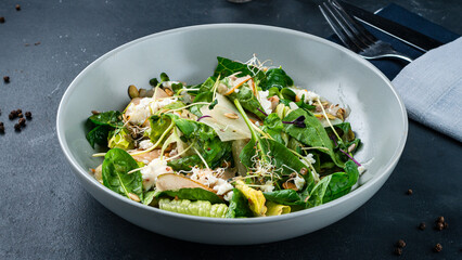 Lunch green salad with cream cheese, lettuce, pear, spinach, microgreens, pumpkin and sunflower seeds.
