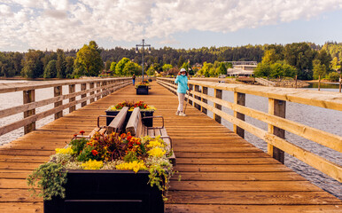 Enjoying a stroll on pier with multiple floral planters at Rocky Point Park in Port Moody, BC.