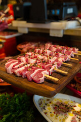 Meat department, showcase with variety of meat in different cuts. Inside an supermarket. Different types of fresh meat arranged in an orderly manner.
