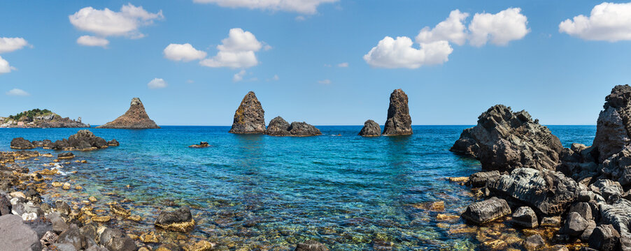 Cyclopean Coast and the Islands of the Cyclops on Aci Trezza town (Italy, Sicily,10 km north of Catania). Known as Isoles Dei Ciclopi Faraglioni.