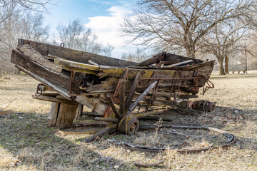 Fototapeta na wymiar old farm wagon slowly rots away in a field