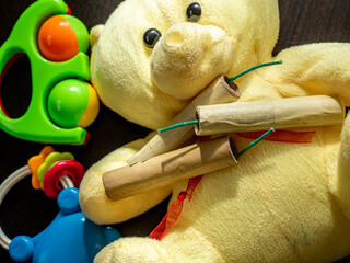 petards and firecrackers and toddler toys close up, conceptual photo of danger for kids	

