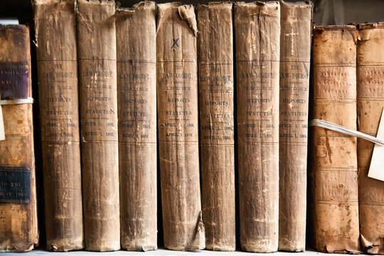 London UK, August 2014 Book shelf of old Law Digest books in archived in various stages of distress 1853c