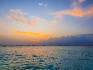 Obraz na płótnie Canvas atmospheric sunset on the beach. Orange clouds. Zanzibar, Tanzania.
