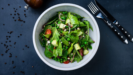 Green salad with cucumbers, lettuce, cherry tomatoes, arugula, beets, green peas, red onion and nuts.