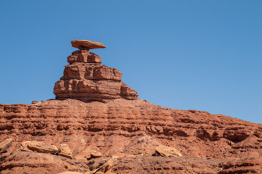 Mexican Hat has many climbers, Utah, eroded layered sandstone wind  water