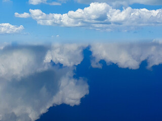 amazing clouds on the blue background. reflection