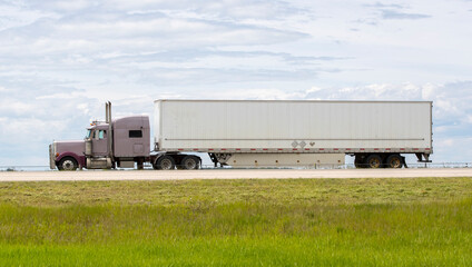 Heavy cargo on the road. A truck hauling freight along a highway. Taken in Alberta, Canada